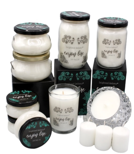 A collection of various sized candles arranged on a flat surface with some in boxes and some displayed in candle holders. Damask Rose and Oud fragrance.